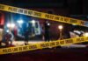 Police tape cordons off a dimly lit crime scene