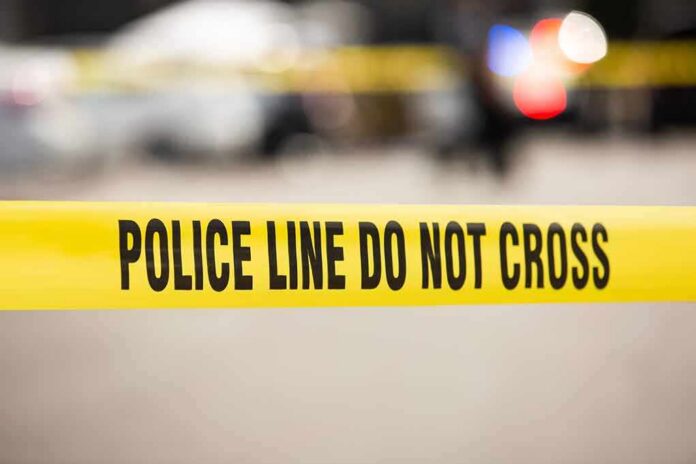 Yellow police tape reading 'POLICE LINE DO NOT CROSS' at a cordoned area
