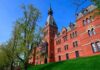 Historic red brick building with tower on a sunny day