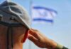 IDF Nails Notorious Motorcycle Kidnapper – Eliminated In Precision Strike Soldier saluting with a blurred flag in the background