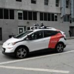 Autonomous test car with roof sensors on a city street