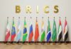BRICS letters above a row of national flags on stands