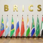 Middle East Flashpoint – BRICS Urges Restraint BRICS letters above a row of national flags on stands