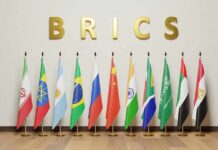 BRICS letters above a row of national flags on stands