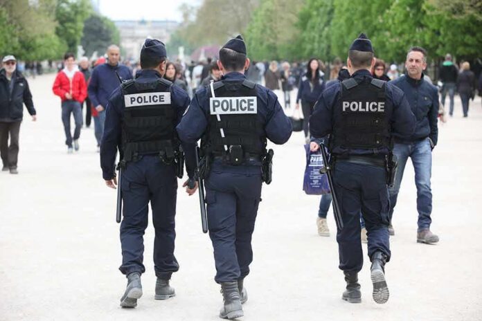 Police officers walking through a crowded park