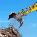 Excavator arm sorting rubble and rebar
