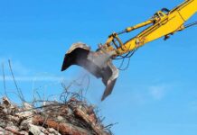 Excavator arm sorting rubble and rebar