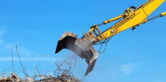 Excavator arm sorting rubble and rebar
