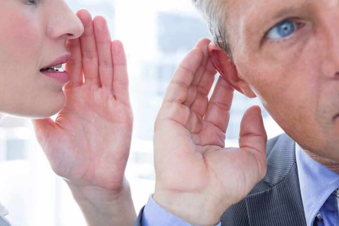 shutterstock_294787076 Woman whispering to a man's ear