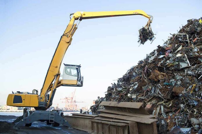 Material handler lifting scrap metal at a junkyard