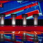 Debate stage with four podiums and colorful star backdrop