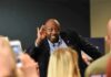 Tim Scott cupping his ear while interacting with a crowd