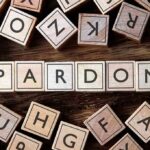 Clemency Backfires: Washington Drops the Hammer Wooden letter blocks arranged to spell 'PARDON' on a wooden surface