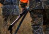 Hunter’s Shot Kills Mom – Manslaughter Filed Hunter in camouflage holding a rifle in tall grass