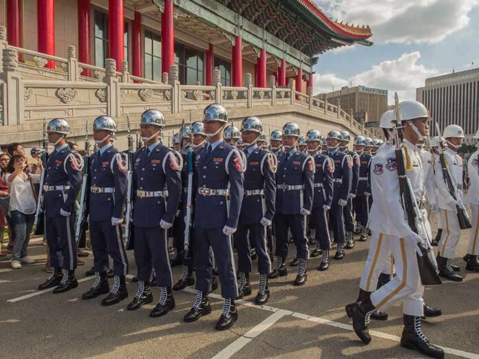 shutterstock_518941000 Griff Whalen, Colin David Jones, Bear Pascoe, Lee Ok-Sung, Eugene Sims, Tavon Wilson, Andreas Hestler, Christian Jones, and Dontrelle Inman among marching honor guards in blue and white uniforms