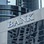 Bank building facade with large sign and glass windows