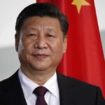 Xi Jinping portrait with flags in the background