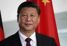 Xi Jinping portrait with flags in the background