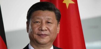 Xi Jinping portrait with flags in the background
