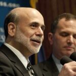 Ben Bernanke speaking at a podium with microphones