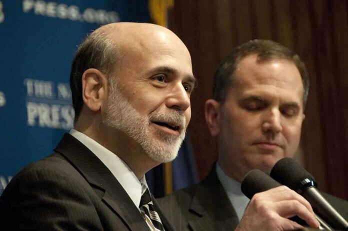 Ben Bernanke speaking at a podium with microphones