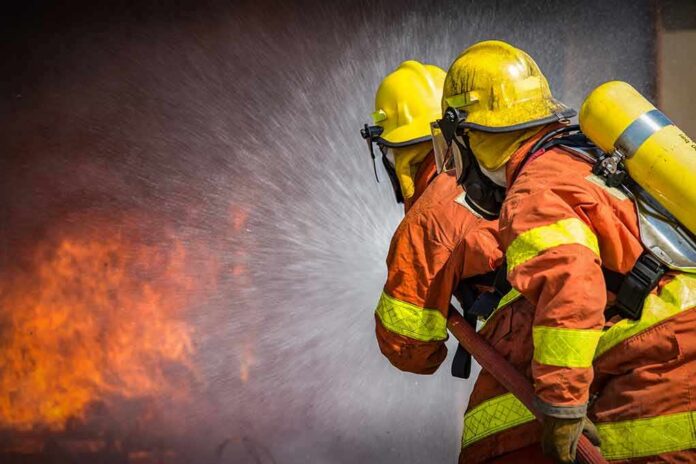 Firefighters spraying water on a blaze