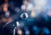 microphone on a stand with blurred stage lights