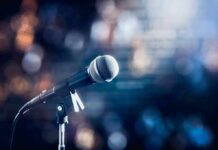 microphone on a stand with blurred stage lights