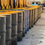 Fuel Spike Averted – But At What Cost? Rows of industrial metal barrels with yellow lids