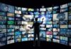 Person interacting with curved wall of digital screens