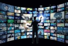 Deepfake Ads – Voters Blindsided By Synthetic Smears Person interacting with curved wall of digital screens