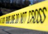 Bus Siege After Blazing Home Horror Yellow police tape stretched across an outdoor scene