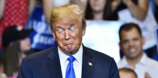 Hecklers Swarm Trump Rally – Mayhem Erupts Donald Trump with eyes closed and pursed lips at an event