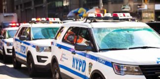 Rush-Hour Gunfire Freezes GWB NYPD police SUVs parked in a row on a city street