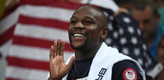 Bet Paid Off – Mayweather Took Everything Floyd Mayweather Jr. smiling and cheering with a towel over his shoulders