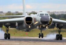 Military jet bomber landing on runway