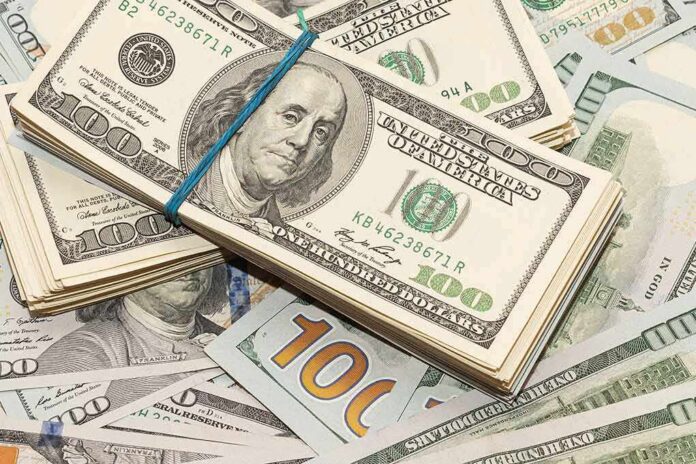 Stack of US hundred-dollar bills bound with a blue band