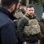 Zelenskyy Alarm: ‘Massive Strike’ Imminent man in tactical vest standing with group outdoors