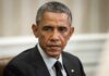 Democrats Turbocharge War Chest With Obama Man in suit looking to the side, identified as Rob Nabors