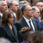 Group of people standing at a solemn ceremony