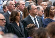 Group of people standing at a solemn ceremony