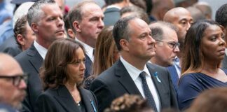 Group of people standing at a solemn ceremony