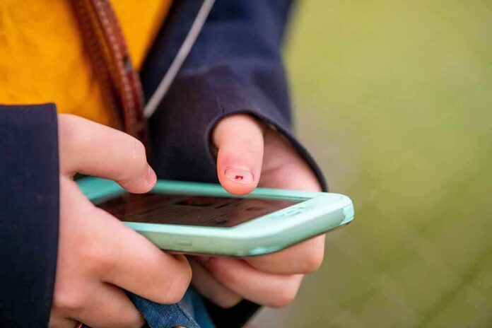 Hands holding a smartphone with a mint-green case