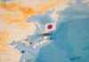 Japanese flag pin marking Japan on a world map