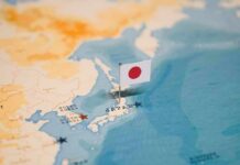Japanese flag pin marking Japan on a world map