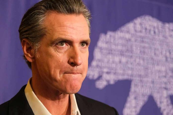 Gavin Newsom at a press event with a purple backdrop