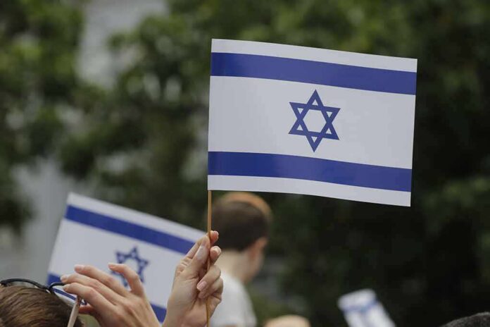 Israeli flag held aloft at an outdoor gathering