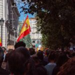 Spain’s High Court SLAMS Mass Child Pushbacks Crowd with Spanish flags in a city street
