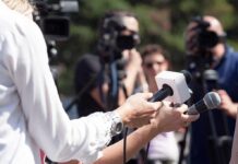 Trump Comment Hijacks Ohio Ad Firestorm Reporters hold microphones during an outdoor press interview
