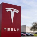 EU Showdown: Tesla Safety Claims Shredded Tesla dealership sign in front of parking lot